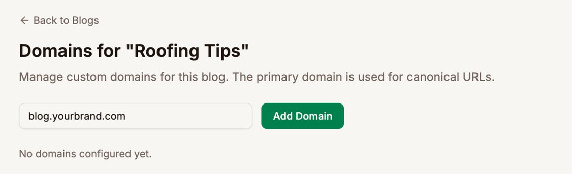 The Domains page for Roofing Tips with blog.yourbrand.com typed in the domain field next to the Add Domain button, and No domains configured yet below